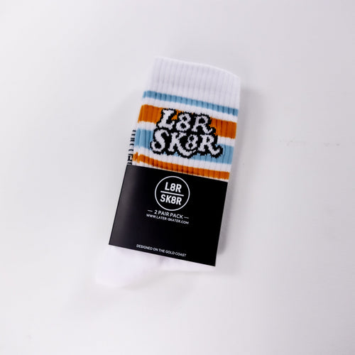 A single white crew sock with blue and orange stripes and a black-and-white 'L8R SK8R' logo, wrapped in a black retail sleeve on a plain white background.